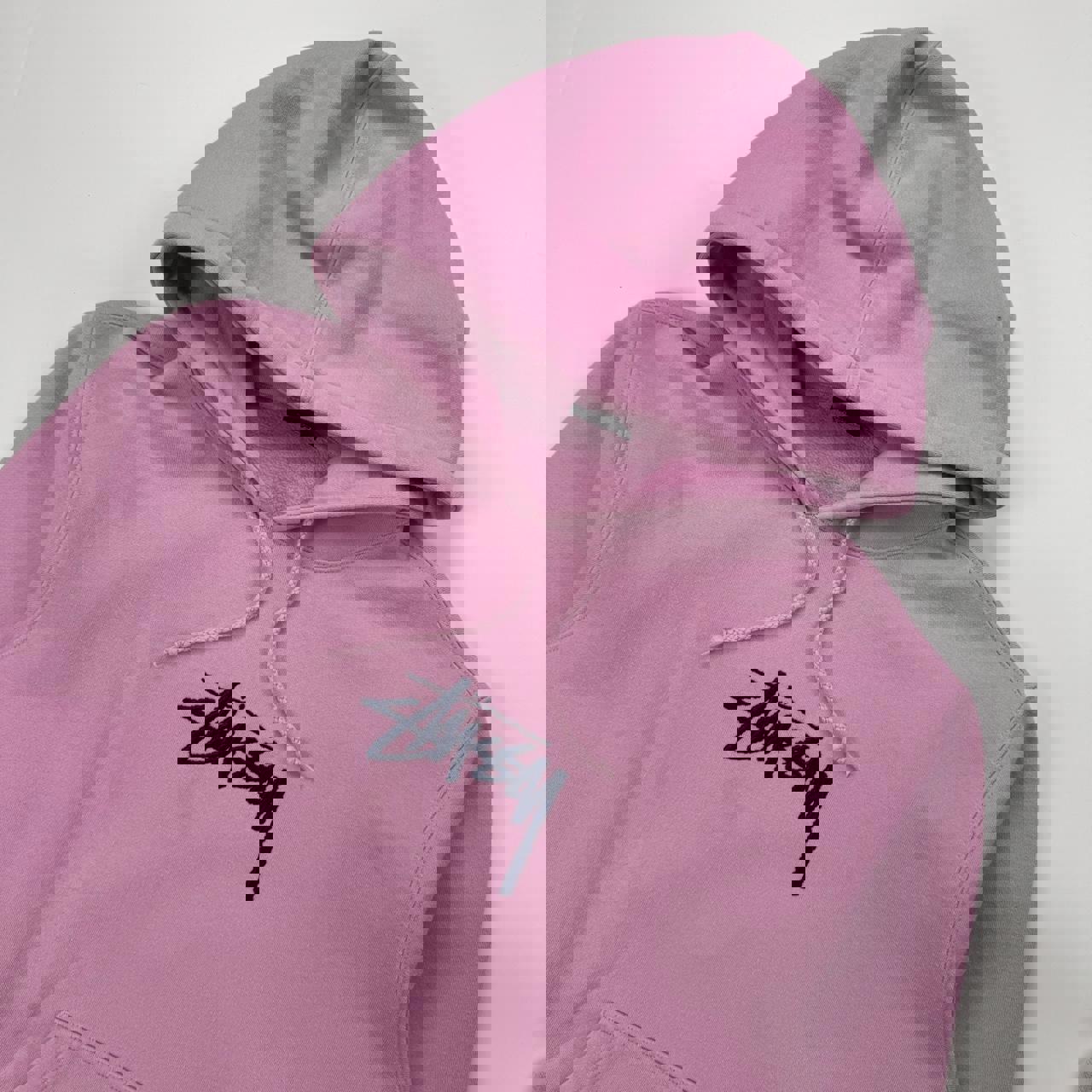 Stussy hoodie in pink with navy blue embroidered logo.