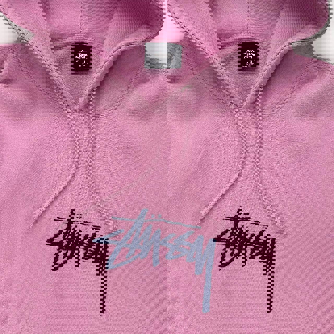 Stussy hoodie in pink with navy blue embroidered logo.