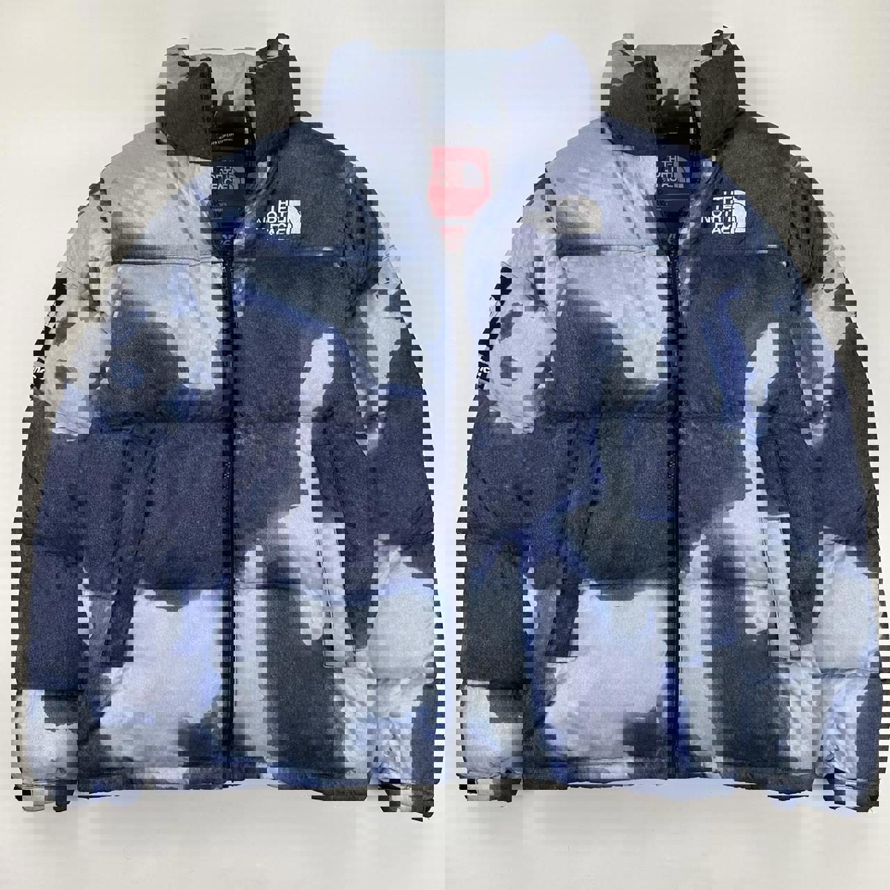 Supreme x The North Face TNF Bleached Denim Print Nuptse Puffer jacket in blue. Released in FW21.