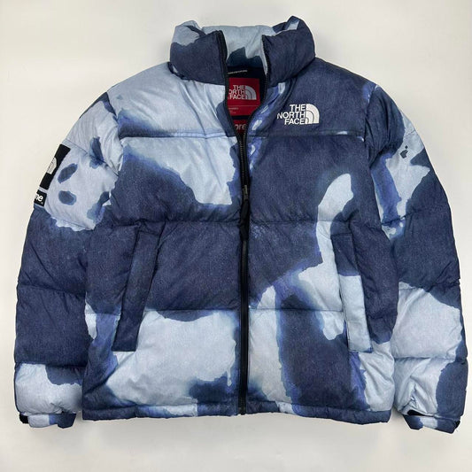Supreme x The North Face TNF Bleached Denim Print Nuptse Puffer jacket in blue. Released in FW21.