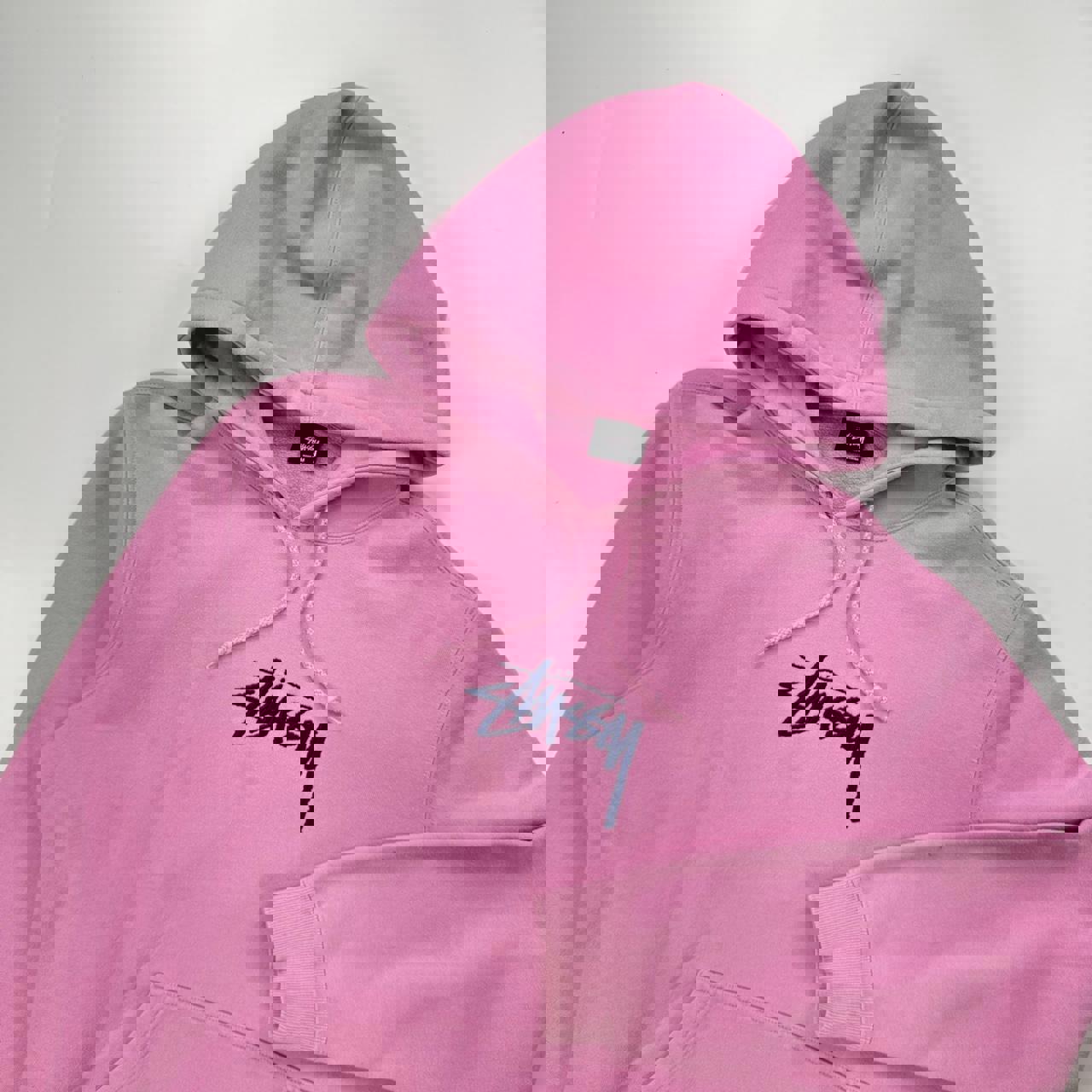 Stussy hoodie in pink with navy blue embroidered logo.