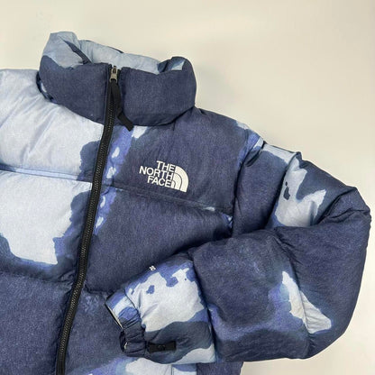 Supreme x The North Face TNF Bleached Denim Print Nuptse Puffer jacket in blue. Released in FW21.