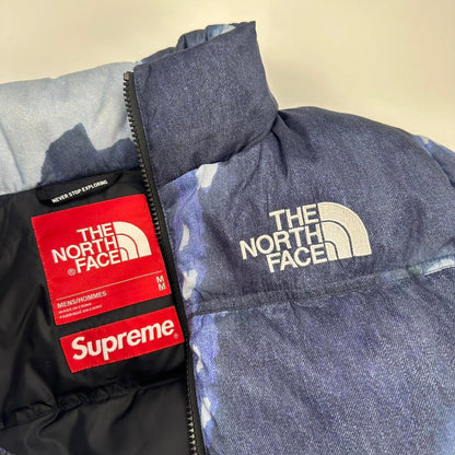 Supreme x The North Face TNF Bleached Denim Print Nuptse Puffer jacket in blue. Released in FW21.