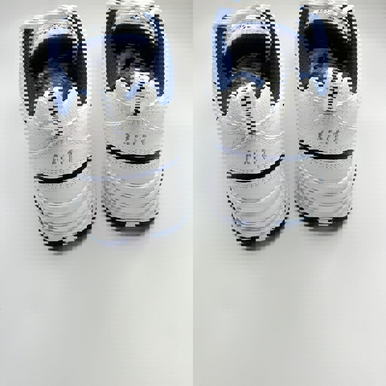 Nike Air Monarch sneakers in blue and white.